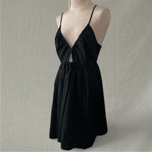 Black mini dress with tie detail at back, deep v neck and cutout detail at front